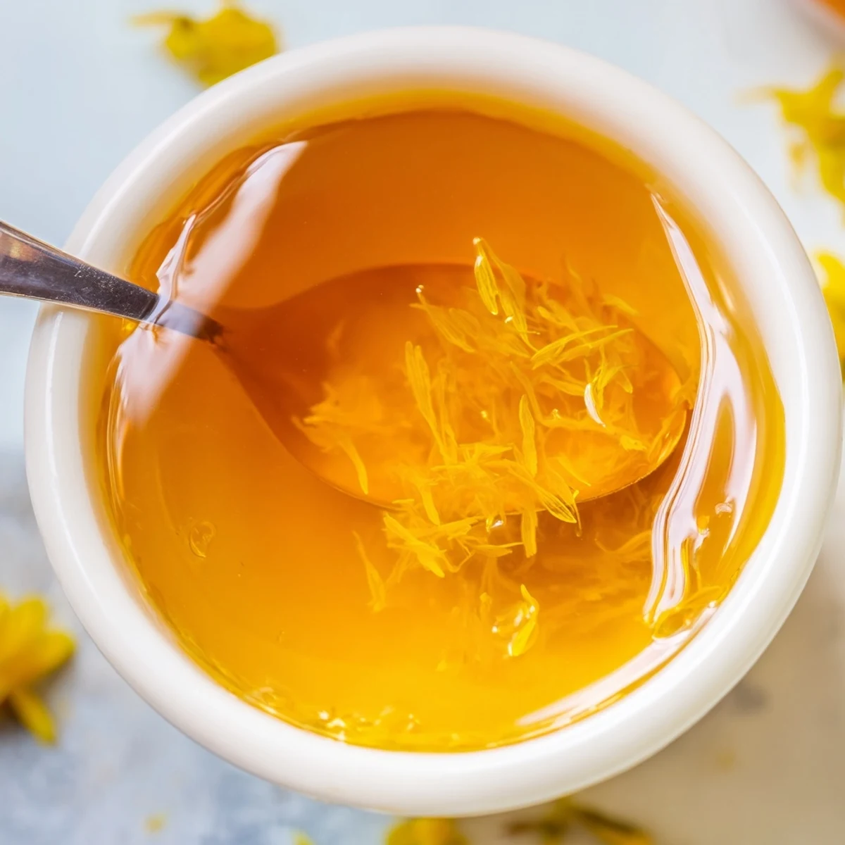 A jar of homemade fresh dandelion jelly glowing with sunny springtime floral sweetness