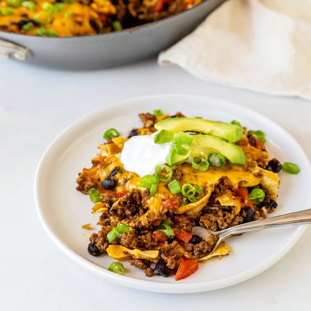 Warm Beef Skillet Enchiladas served hot with lime wedge and crisp chips