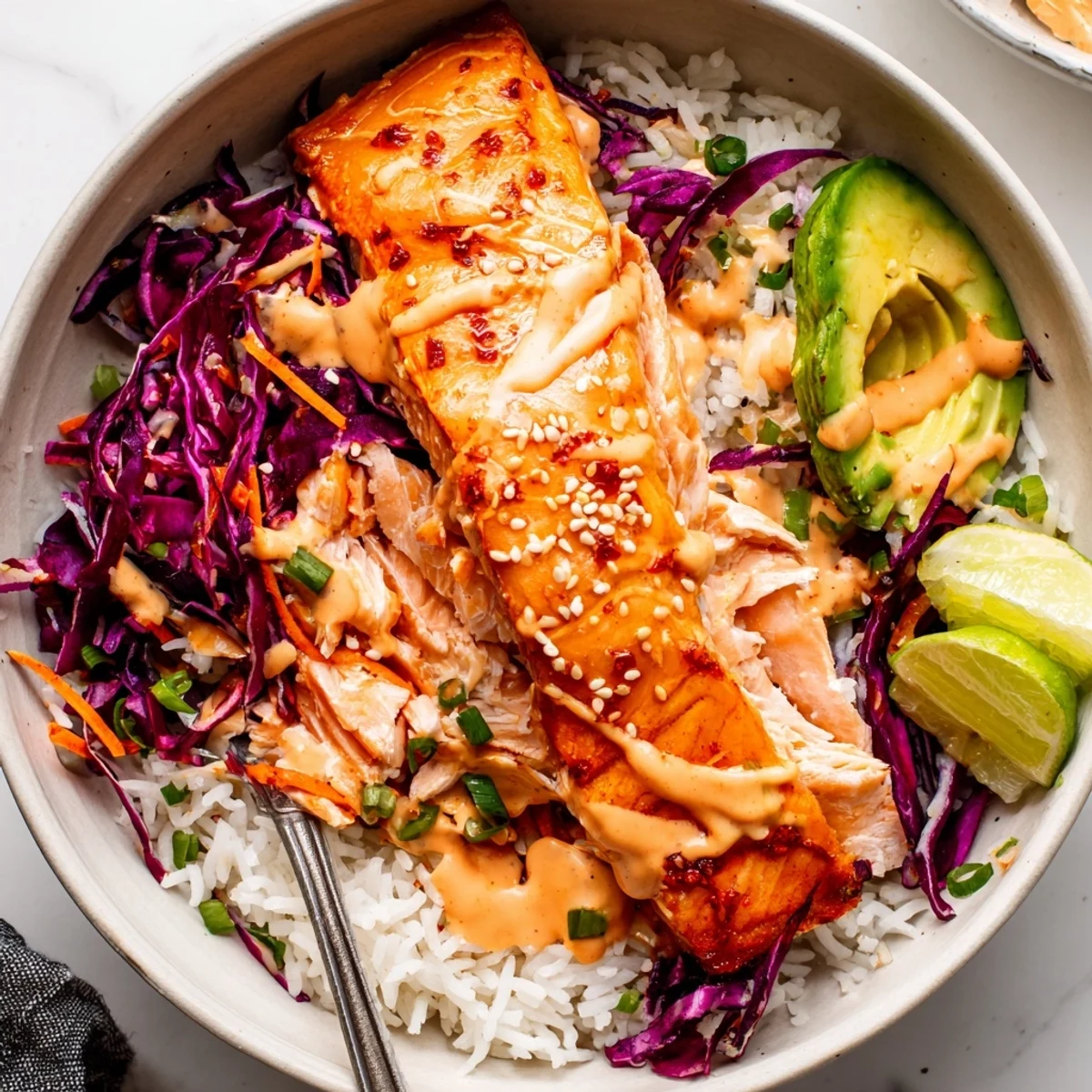 Fluffy rice, avocado, scallions, topped with salmon from Bang Bang Salmon Bowls Recipe.