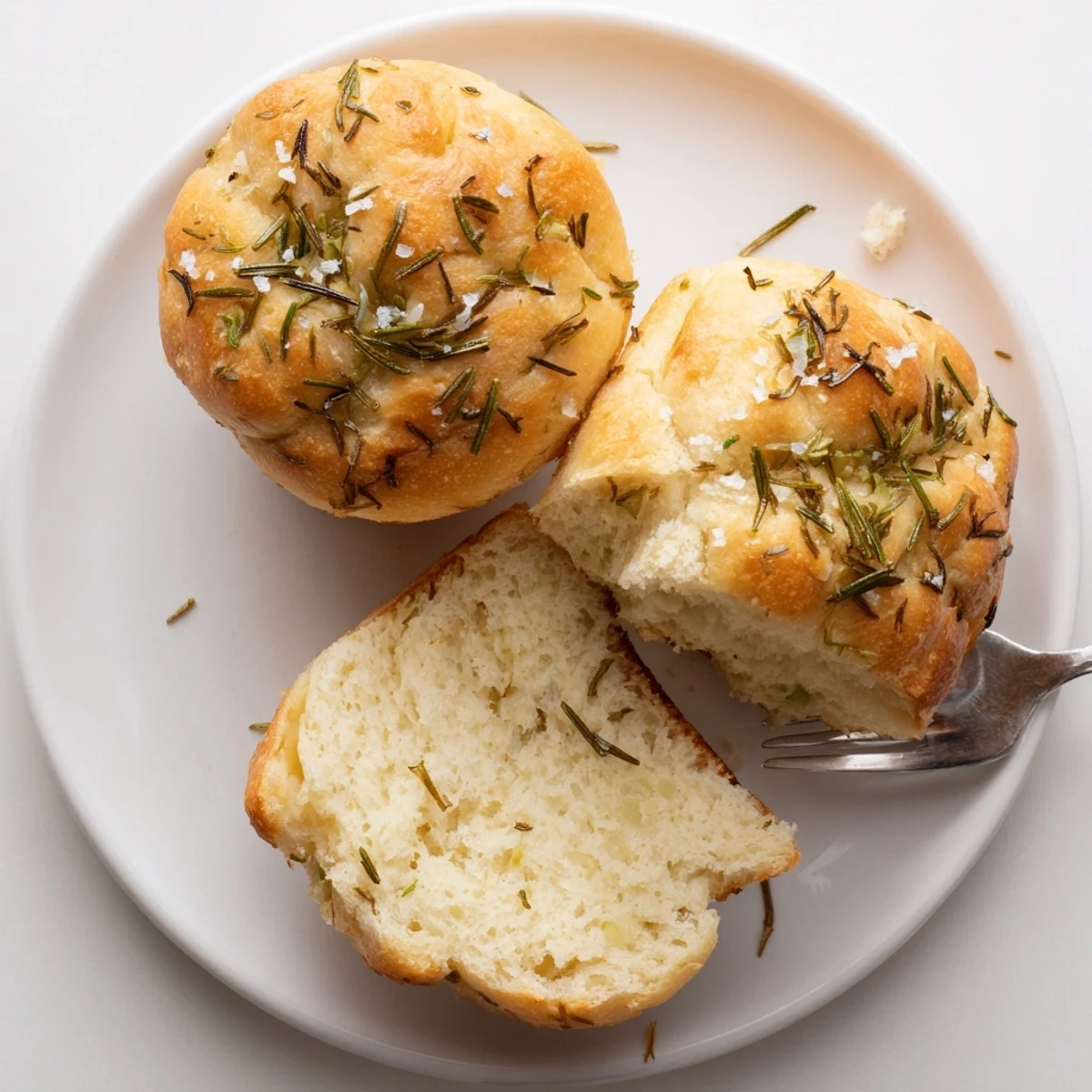 A platter of Garlic Rosemary Focaccia Muffins, fragrant rosemary and roasted garlic