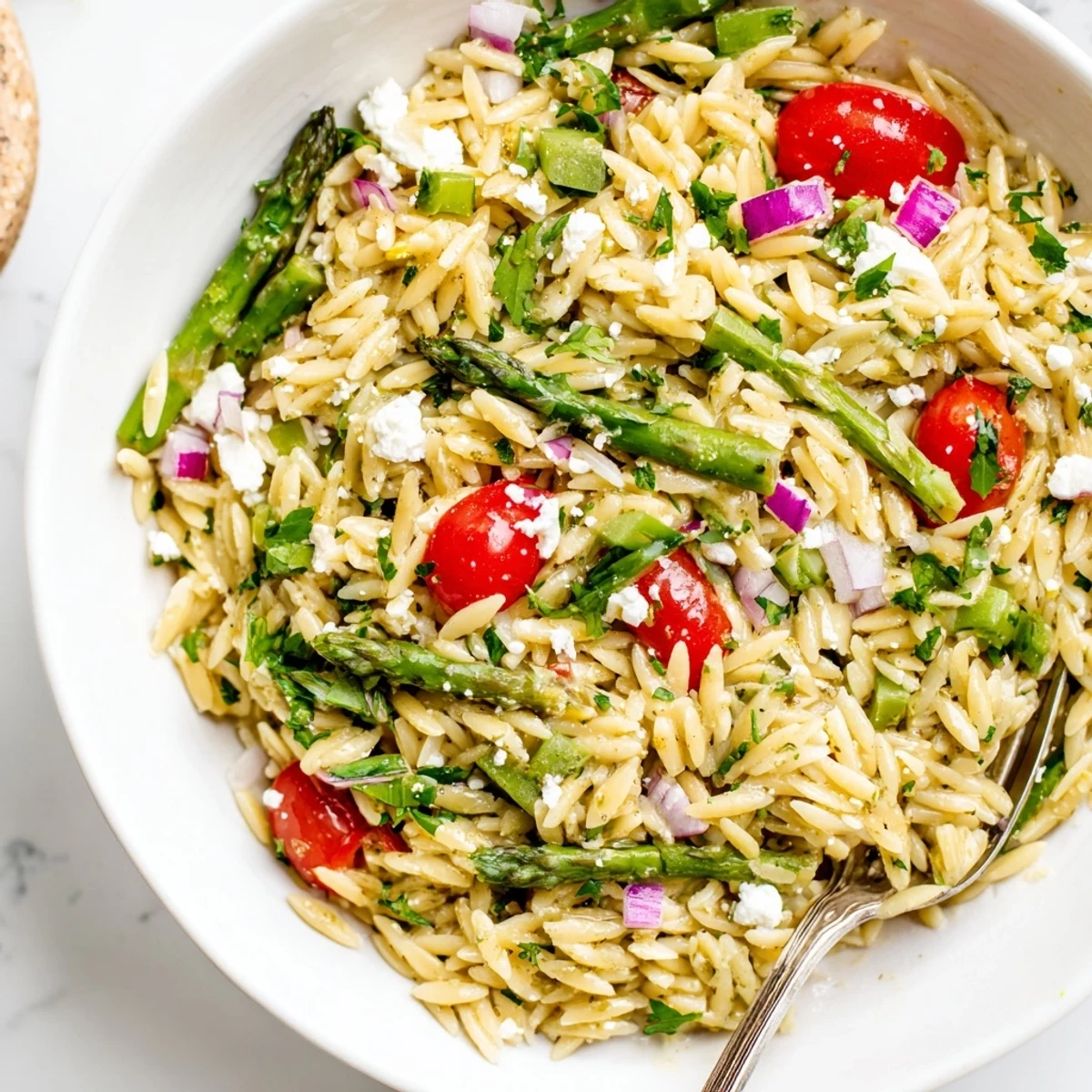 Zesty Asparagus Orzo Salad With Lemon Vinaigrette served in bowl, bright herb garnish