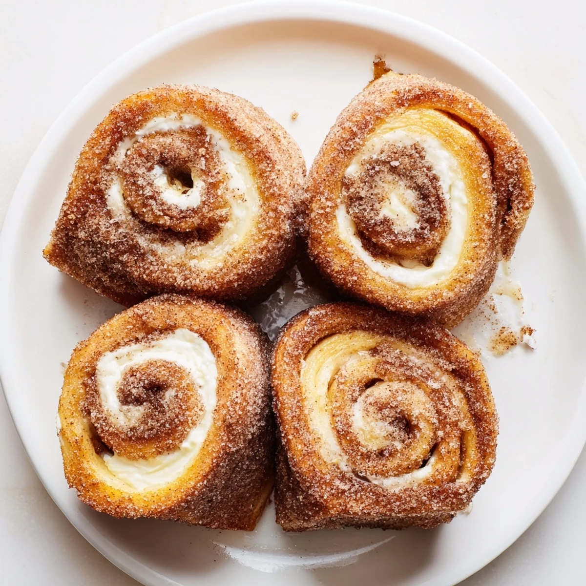 Morning skillet of Cinnamon Roll French Toast Roll Ups, golden edges, soft filling