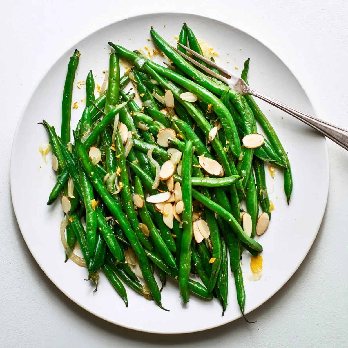 Golden green beans cooked with garlic and olive oil, steaming hot in a cast iron skillet.