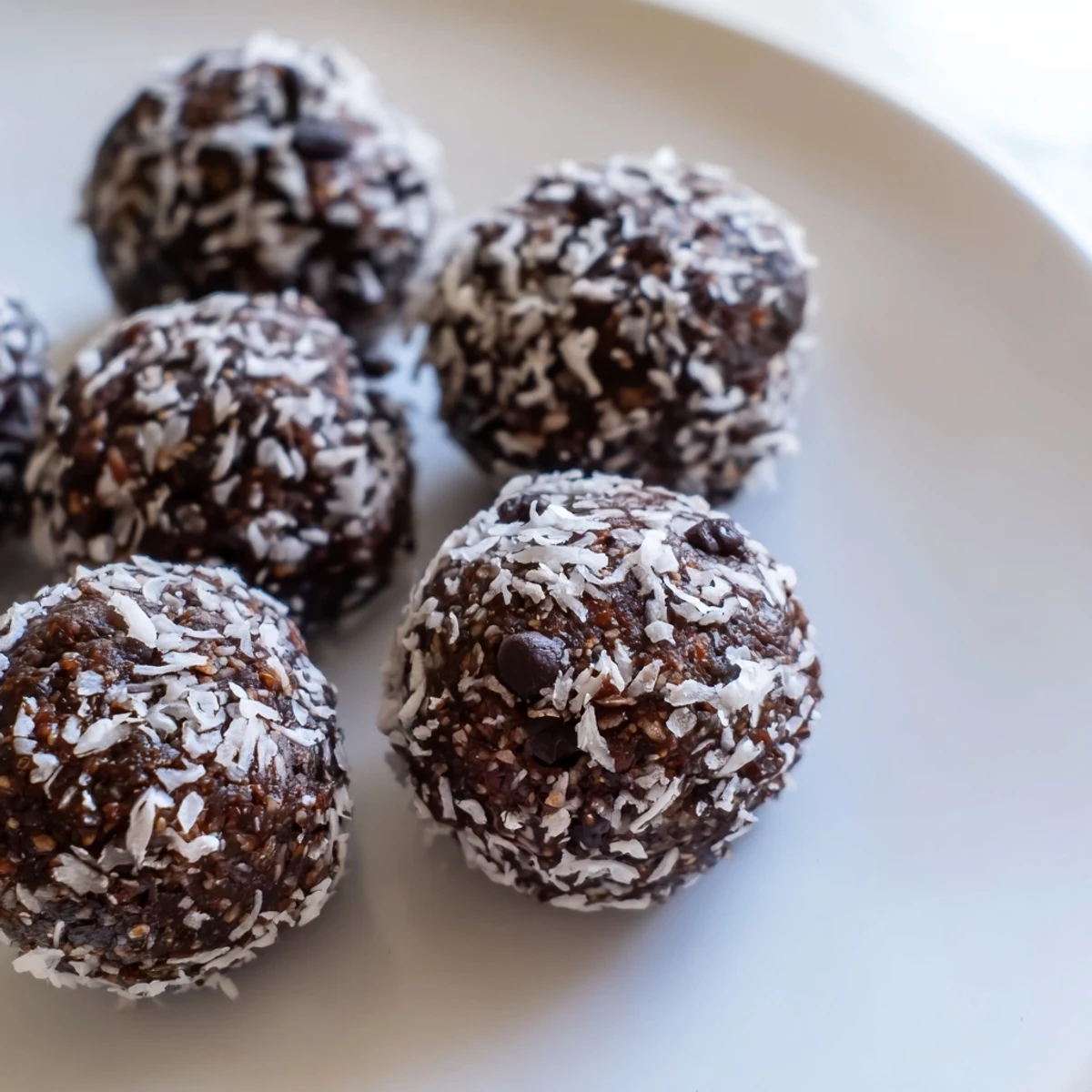 Gluten-free no bake brownie bites arranged on a white serving plate