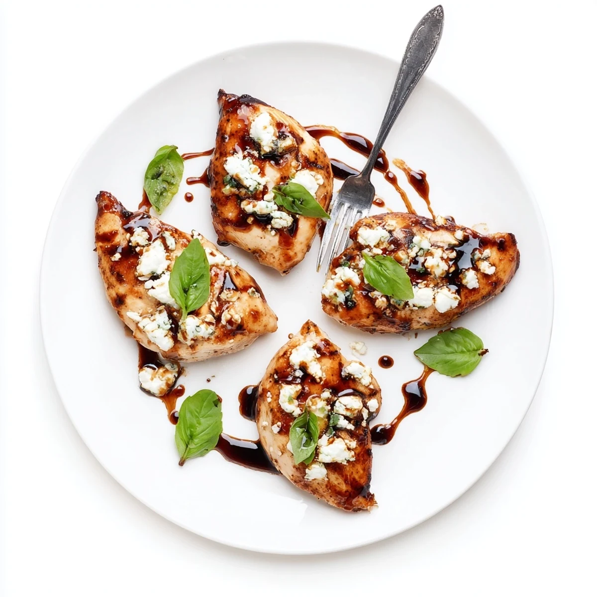 Sizzle-seared Sweet Tangy Balsamic Chicken with Goat Cheese & Basil, drizzled with balsamic reduction.
