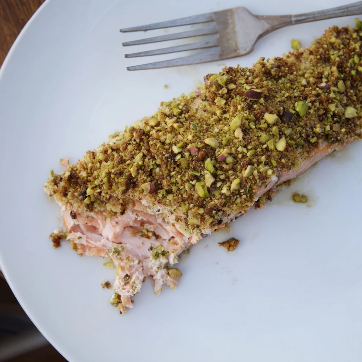 Baked maple pistachio salmon glistening with sweet glaze and bright lemon zest