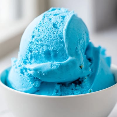 Vibrant Blue Moon Ice Cream in a chilled bowl showing smooth velvety texture